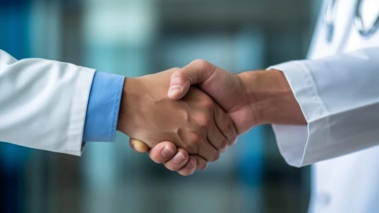 Two clinicians shaking hands